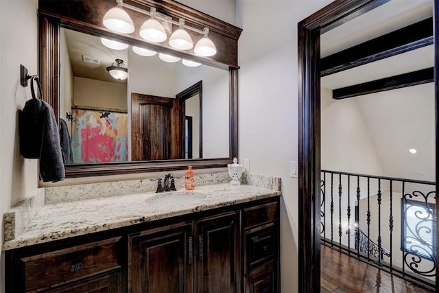 full bath with visible vents, beam ceiling, wood finished floors, and vanity