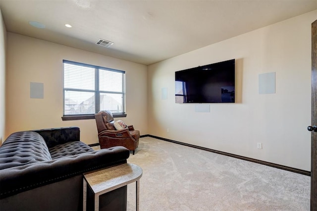 living room featuring light colored carpet, visible vents, and baseboards