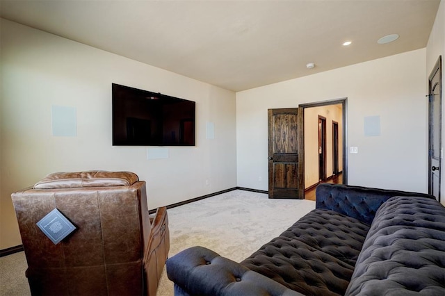 carpeted living area featuring recessed lighting and baseboards