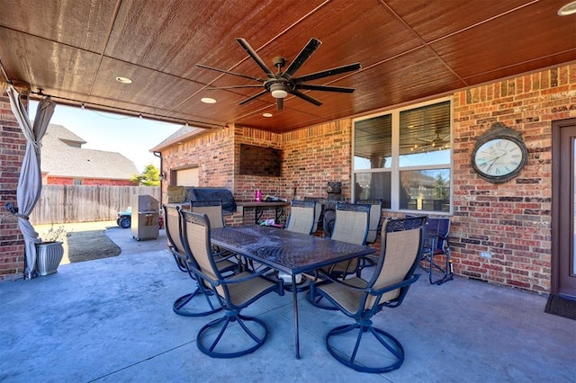 view of patio / terrace with outdoor dining area, a grill, a ceiling fan, and fence