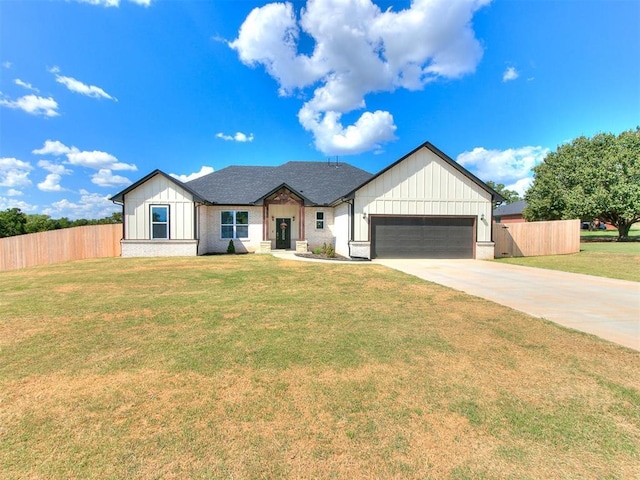 modern inspired farmhouse with a garage, driveway, board and batten siding, and fence