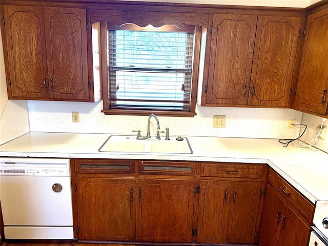 kitchen featuring a sink, brown cabinetry, light countertops, and dishwasher