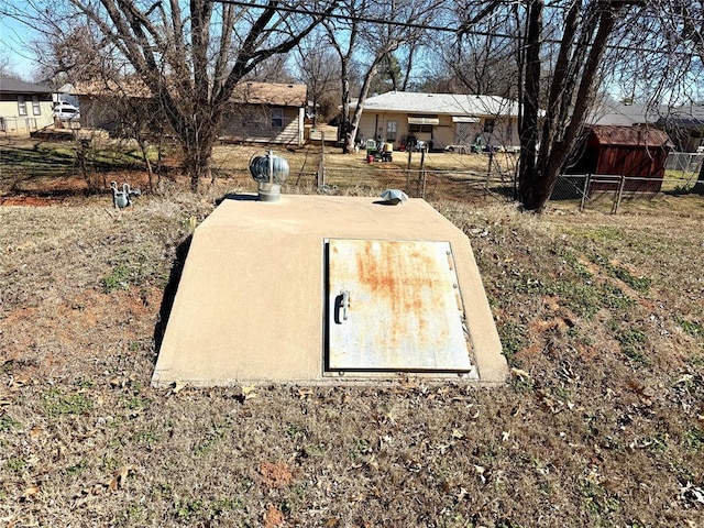 view of storm shelter with fence