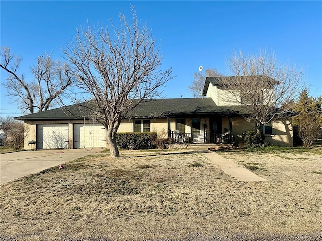 view of front facade with a garage, driveway, a porch, and brick siding