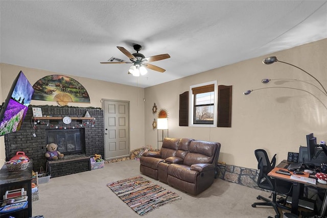 interior space with visible vents, a ceiling fan, a textured ceiling, carpet flooring, and a brick fireplace