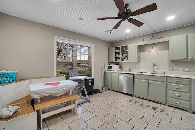 kitchen with a sink, open shelves, stainless steel dishwasher, green cabinets, and white microwave