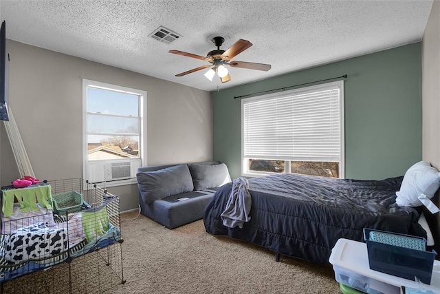 bedroom featuring cooling unit, a ceiling fan, visible vents, a textured ceiling, and carpet flooring