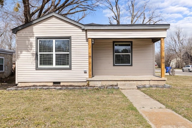 bungalow-style house with covered porch, crawl space, and a front yard