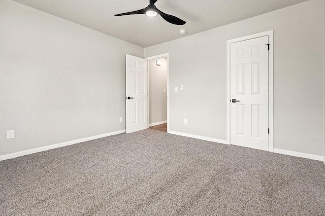 unfurnished bedroom with ceiling fan, baseboards, and carpet flooring