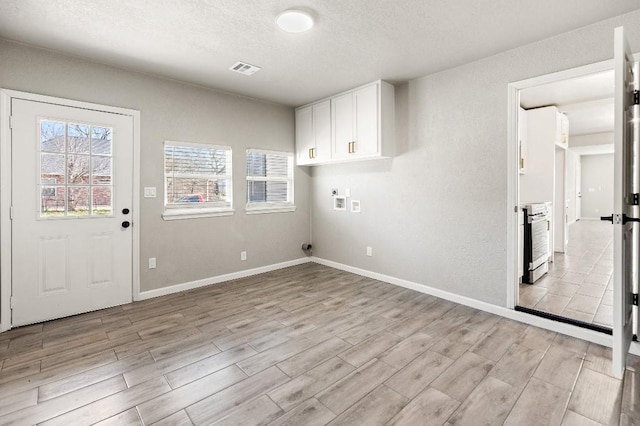 laundry room with washer hookup, cabinet space, visible vents, light wood-type flooring, and baseboards