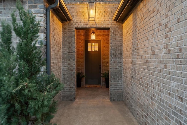 entrance to property featuring brick siding