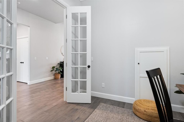 office space featuring baseboards, french doors, and dark wood-style flooring