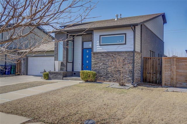 view of front of property with concrete driveway, brick siding, fence, and an attached garage