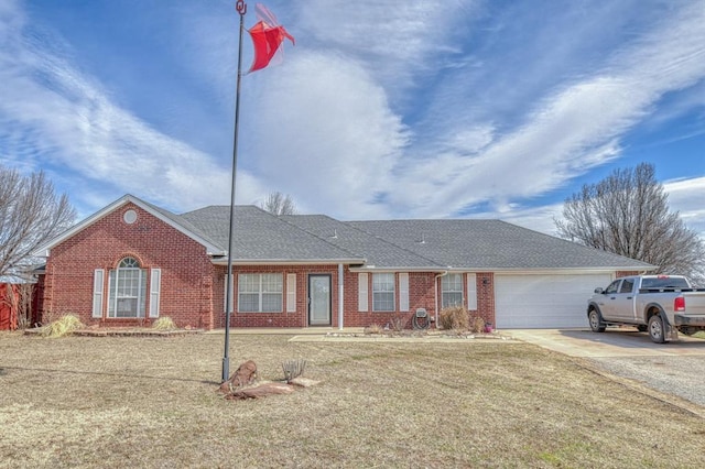 ranch-style home featuring a garage, brick siding, a shingled roof, driveway, and a front yard