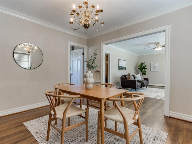 dining room with ceiling fan with notable chandelier, baseboards, dark wood-style flooring, and ornamental molding