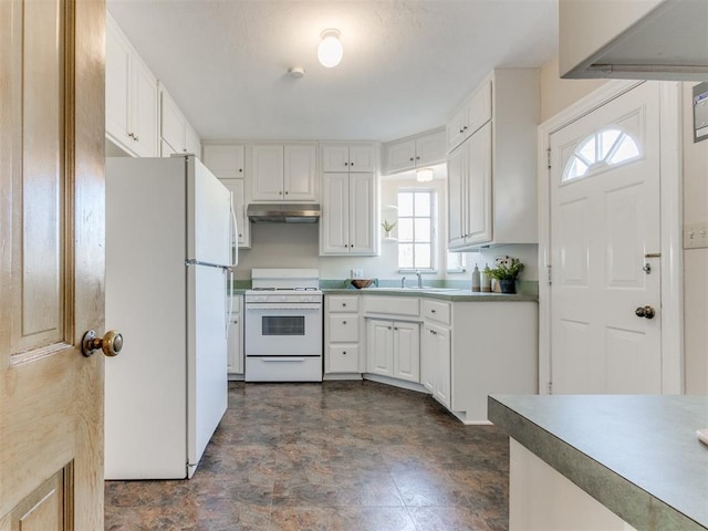 kitchen featuring white appliances, under cabinet range hood, and white cabinetry