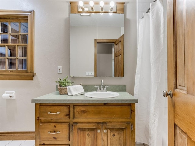 bathroom featuring tile patterned flooring and vanity