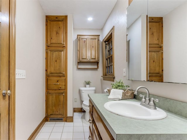 bathroom with baseboards, visible vents, toilet, tile patterned floors, and vanity