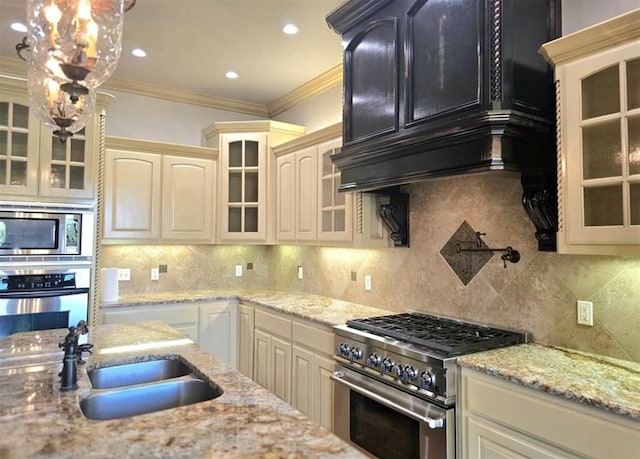 kitchen with ornamental molding, appliances with stainless steel finishes, a sink, and tasteful backsplash