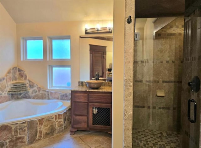 bathroom with a garden tub, a shower stall, vanity, and tile patterned floors