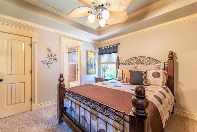 carpeted bedroom featuring ceiling fan, baseboards, a raised ceiling, and crown molding