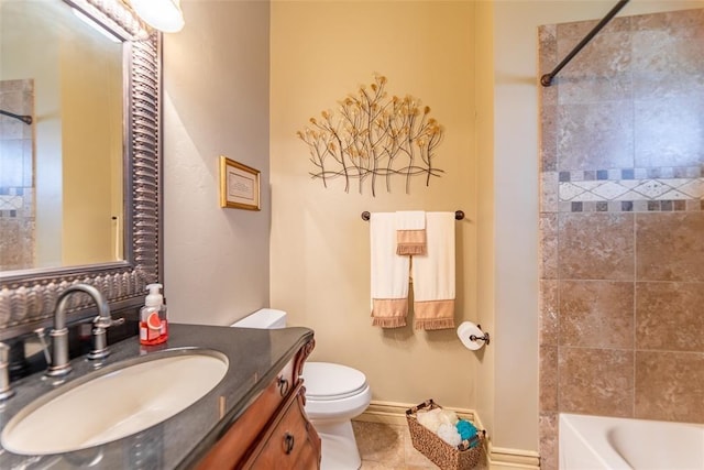 full bath featuring baseboards, toilet, tile patterned floors, vanity, and washtub / shower combination