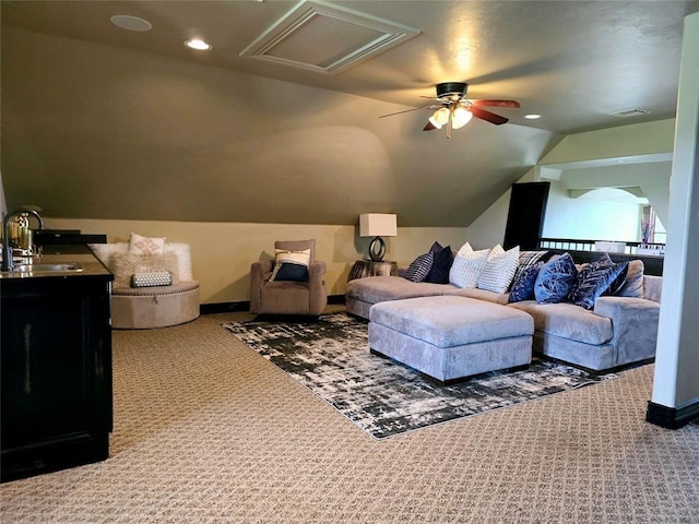 carpeted cinema room with recessed lighting, a sink, visible vents, baseboards, and vaulted ceiling