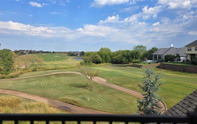 view of community featuring a yard and golf course view