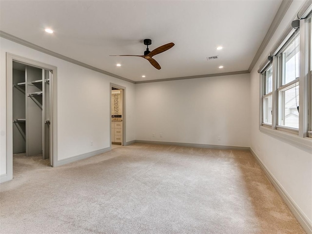 spare room featuring crown molding, recessed lighting, visible vents, light carpet, and baseboards