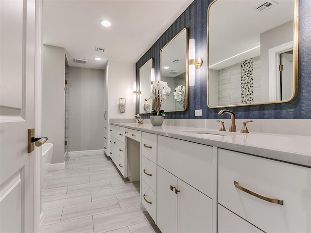 bathroom featuring visible vents, double vanity, recessed lighting, a sink, and a shower stall