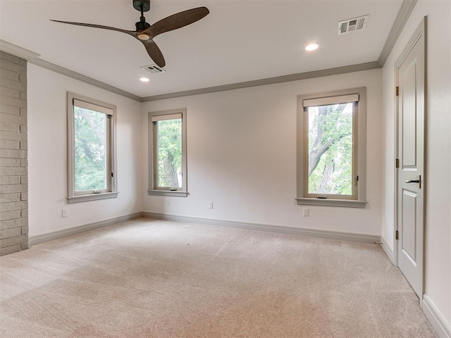 unfurnished room with ornamental molding, carpet flooring, visible vents, and a healthy amount of sunlight