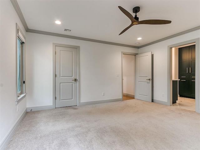 unfurnished bedroom featuring crown molding, baseboards, visible vents, and light colored carpet