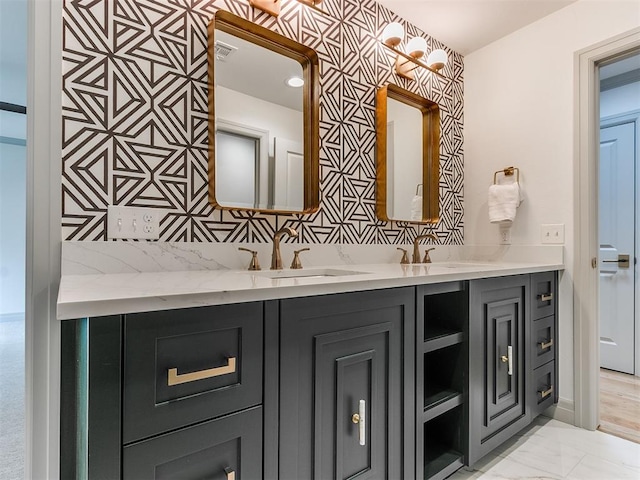 bathroom featuring marble finish floor, visible vents, vanity, and wallpapered walls