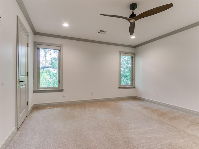 unfurnished room featuring visible vents, light carpet, baseboards, and ornamental molding