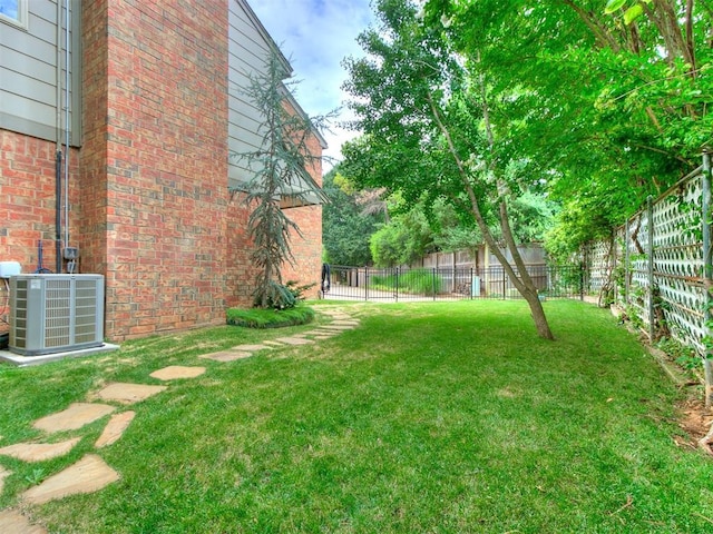 view of yard with cooling unit and fence