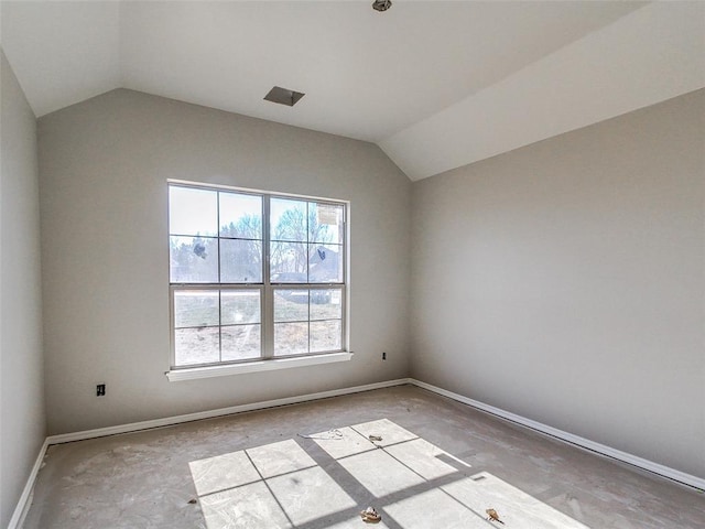 unfurnished room with baseboards and vaulted ceiling