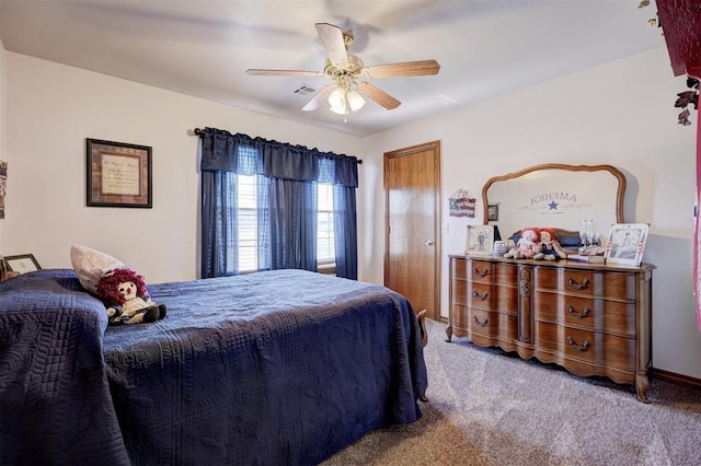 carpeted bedroom featuring ceiling fan and visible vents