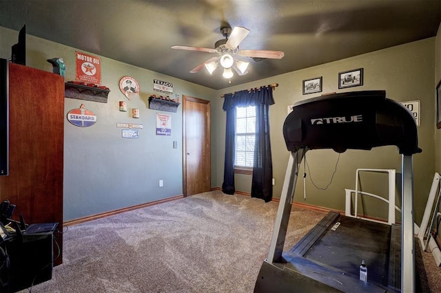 exercise area featuring baseboards, a ceiling fan, and carpet flooring