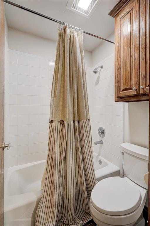 full bathroom featuring toilet, shower / bath combo, and visible vents