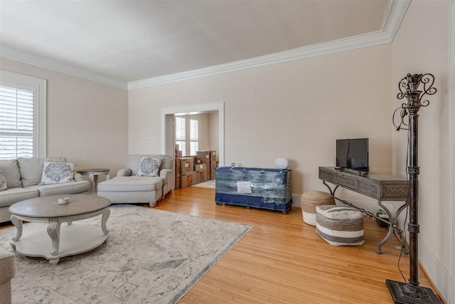 living room with wood finished floors and crown molding