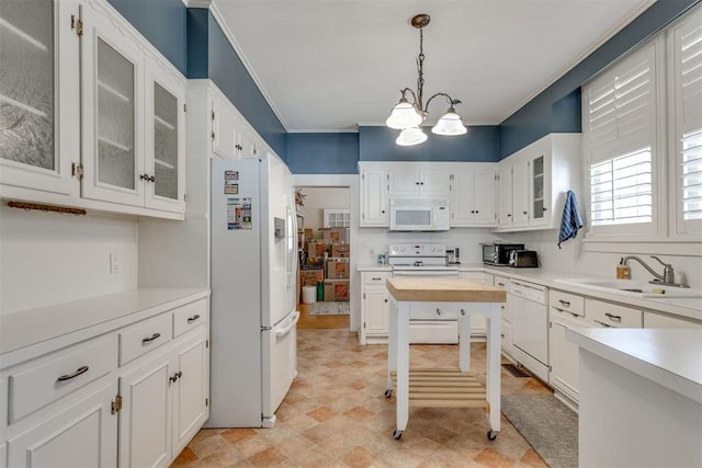 kitchen featuring white appliances, light countertops, a sink, and white cabinetry