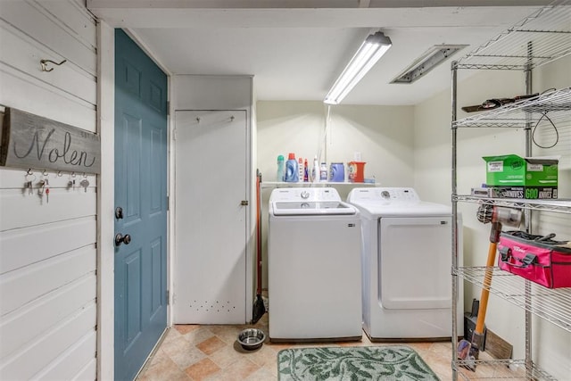 clothes washing area featuring laundry area and washer and clothes dryer