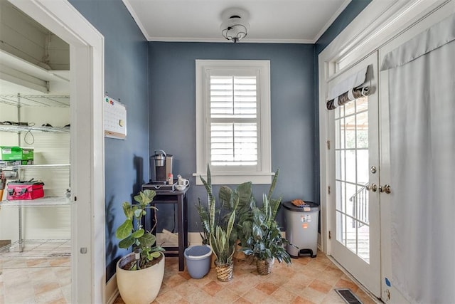 doorway with ornamental molding, visible vents, and a healthy amount of sunlight