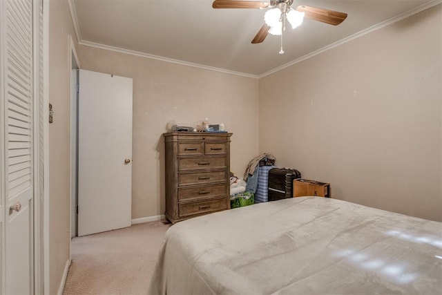 bedroom with light carpet, ceiling fan, baseboards, and crown molding