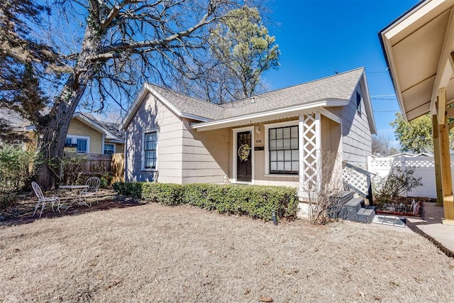 bungalow-style house with fence and roof with shingles