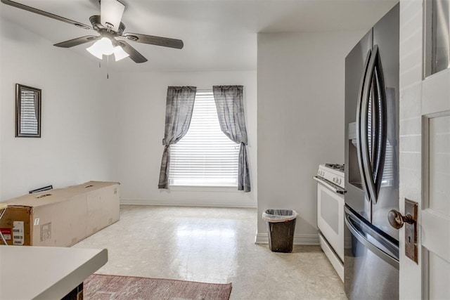 kitchen with a ceiling fan, baseboards, stainless steel fridge with ice dispenser, and white gas range oven