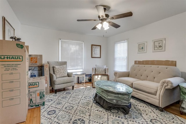 living room featuring ceiling fan and wood finished floors