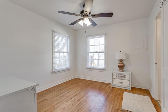 unfurnished bedroom featuring light wood-style floors, ceiling fan, and baseboards