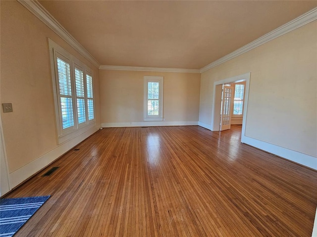 804 N Willow St, Pauls Valley, OK 73075 - empty room with a wealth of natural light, visible vents, crown molding, and hardwood / wood-style floors