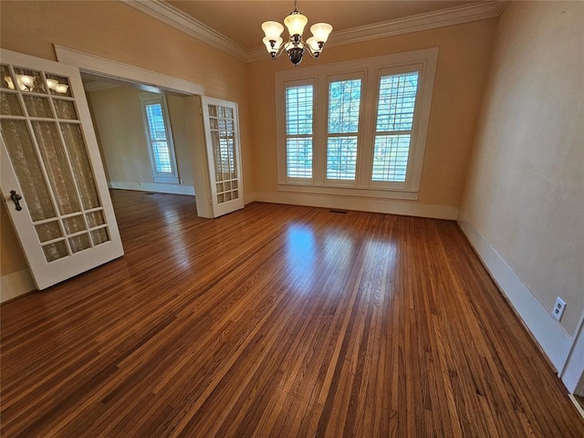 804 N Willow St, Pauls Valley, OK 73075 - spare room featuring dark wood finished floors, baseboards, a notable chandelier, and crown molding